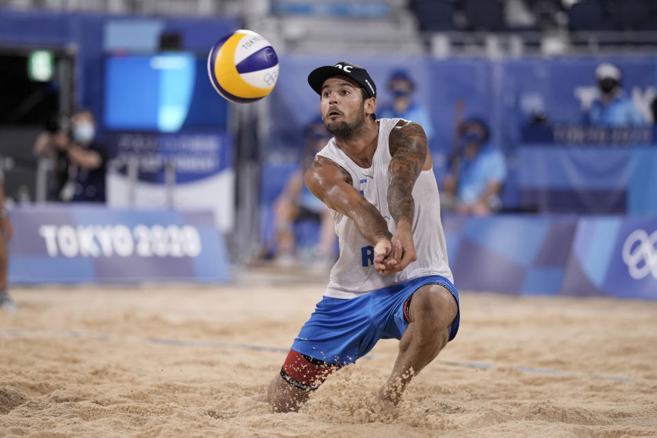 Viacheslav Krasilnikov, of the Russian Olympic Committee, returns a shot during a men's beach volleyball semifinal match against Qatar at the 2020 Summer Olympics, Thursday, Aug. 5, 2021, in Tokyo, Japan. (AP Photo/Felipe Dana)