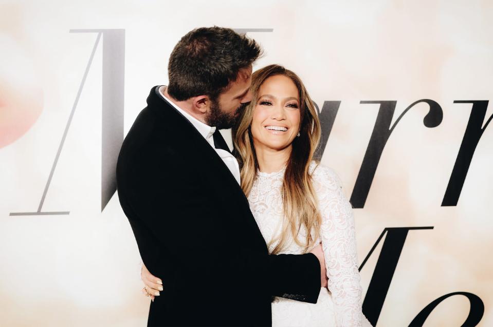 Ben Affleck and Jennifer Lopez posing for photos at a movie premiere