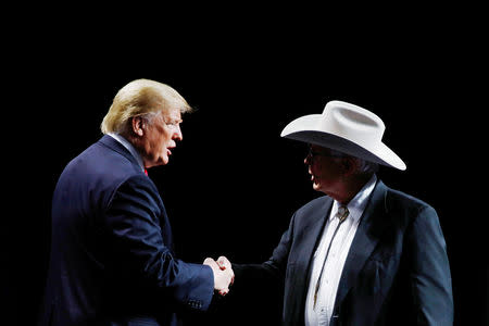 U.S. President Donald Trump greets Arizona farmer Jim Chilton, who addressed the National Farm Bureau Federation's 100th convention in New Orleans, Louisiana, U.S., January 14, 2019. REUTERS/Carlos Barria