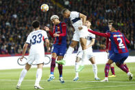 Barcelona's Ronald Araujo, center left, and PSG's Kylian Mbappe go for a header during the Champions League quarterfinal second leg soccer match between Barcelona and Paris Saint-Germain at the Olimpic Lluis Companys stadium in Barcelona, Spain, Tuesday, April 16, 2024. (AP Photo/Joan Monfort)