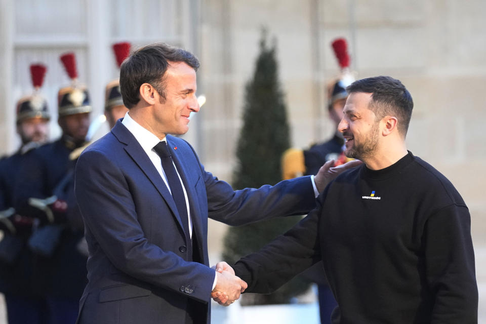 French President Emmanuel Macron, right, welcomes Ukrainian President Volodymyr Zelenskyy at the Elysee palace in Paris, Sunday, May 14, 2023. Ukrainian President Volodymyr Zelenskyy made a surprise visit to Paris for talks Sunday night with French President Emmanuel Macron, extending a multi-stop European tour that has elicited fresh pledges of military support as his country gears up for a counteroffensive against Russian occupation forces. (AP Photo/Michel Euler)