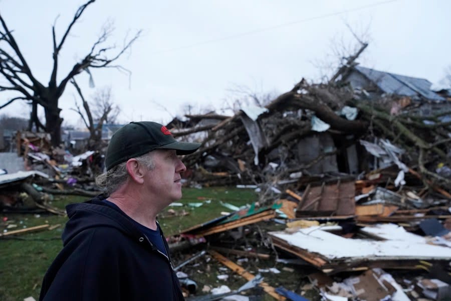 Greg McDougle walks near debris Friday, March 15, 2024, following a severe storm in Lakeview, Ohio. (AP Photo/Joshua A. Bickel)