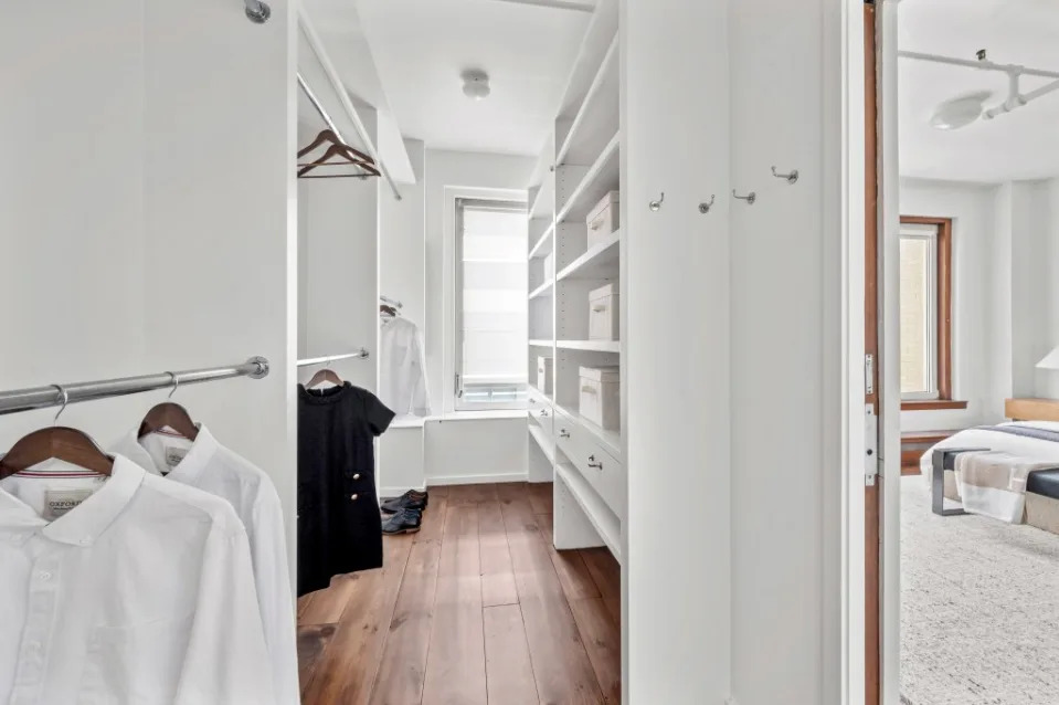 The primary bedroom has a walk-in closet and a dressing room. Carli Biryla