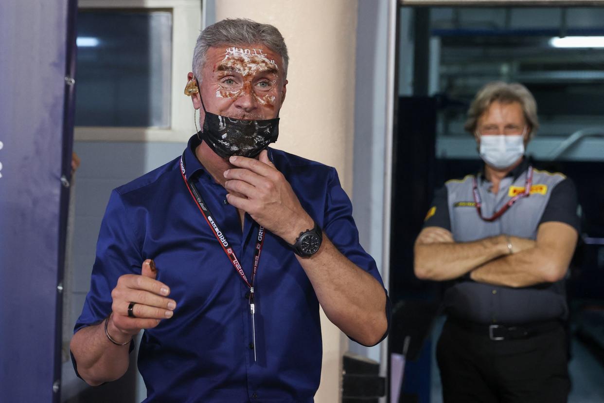 Former F1 driver-turned-pundit David Coulhtard - who is celebrating his birthday - looks on after having cake slammed in his face by Red Bull's Dutch driver Max Verstappen after the qualifying session on the eve of the Bahrain Formula One Grand Prix at the Bahrain International Circuit in the city of Sakhir on March 27, 2021. (Photo by Lars Baron / various sources / AFP) (Photo by LARS BARON/AFP via Getty Images)