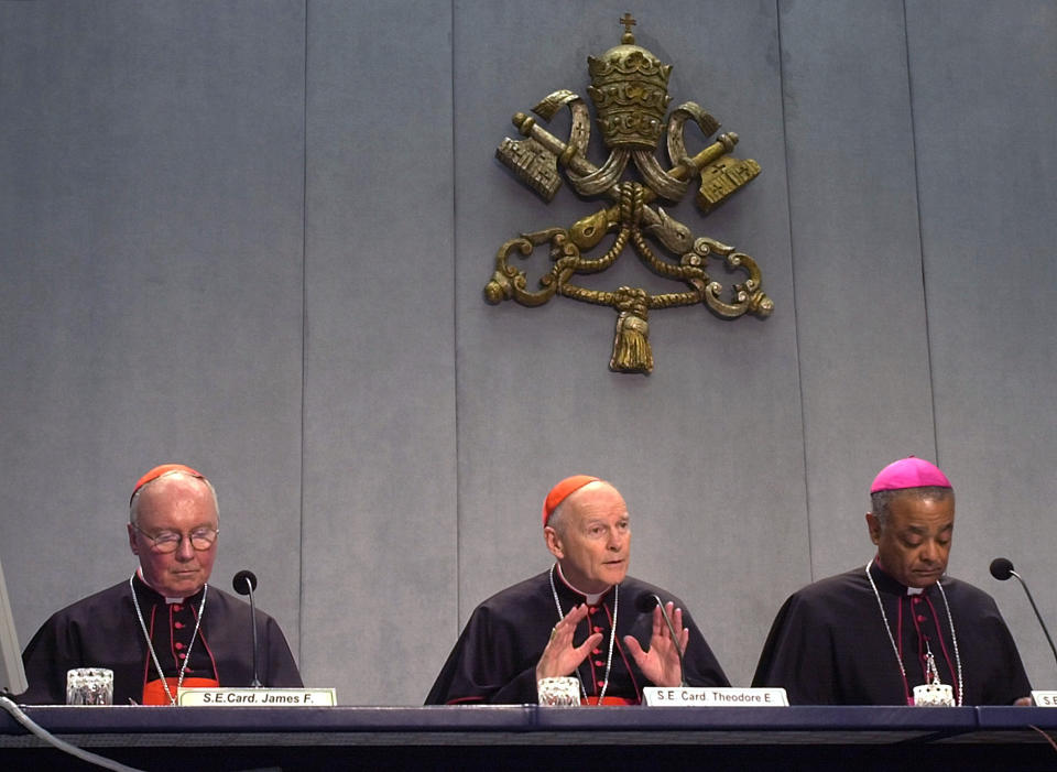 FILE - In this April 24, 2002 file photo, Cardinal James Francis Stafford, left, head of the Pontifical Council for Laymen, Cardinal Theodore Edgar McCarrick of Washington, D.C., center, and United States Catholic Bishops' Conference President Wilton Gregory of Belleville, Ill., attend a news conference at the Vatican concluding a two-day meeting between Pope John Paul II and US cardinals at the Vatican. After an extraordinary meeting sparked by a sex abuse scandal, American Roman Catholic leaders agreed to make it easier to remove priests guilty of sexually abusing minors - but they stopped short of a zero-tolerance policy to dismiss all abusive priests. (AP Photo/Pier Paolo Cito, File)