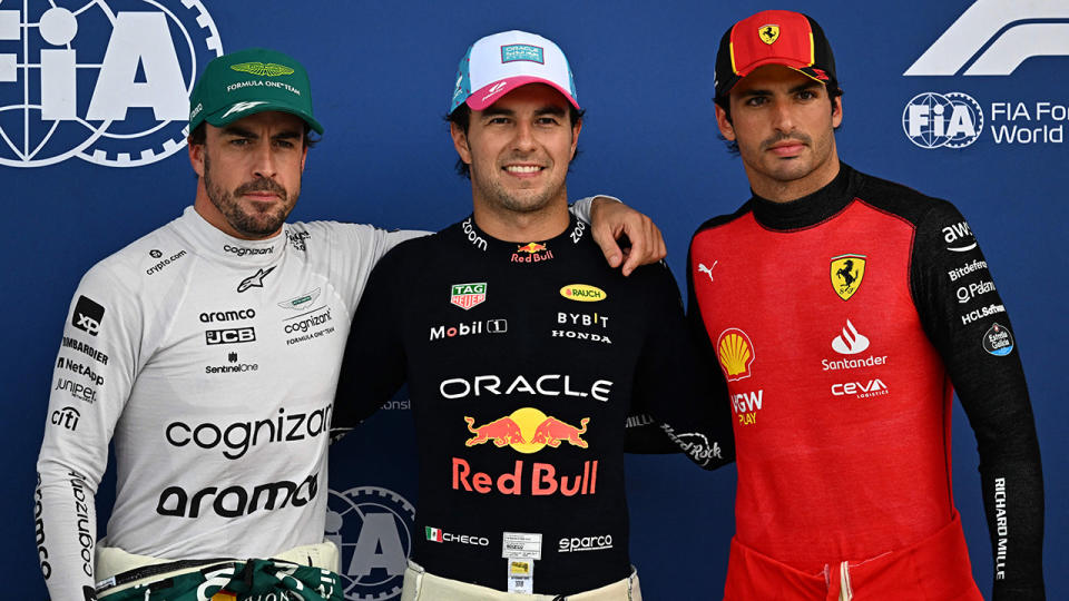 Red Bull's Sergio Perez is pictured between Aston Martin's Fernando Alonso and Ferrari driver Carlos Sainz.