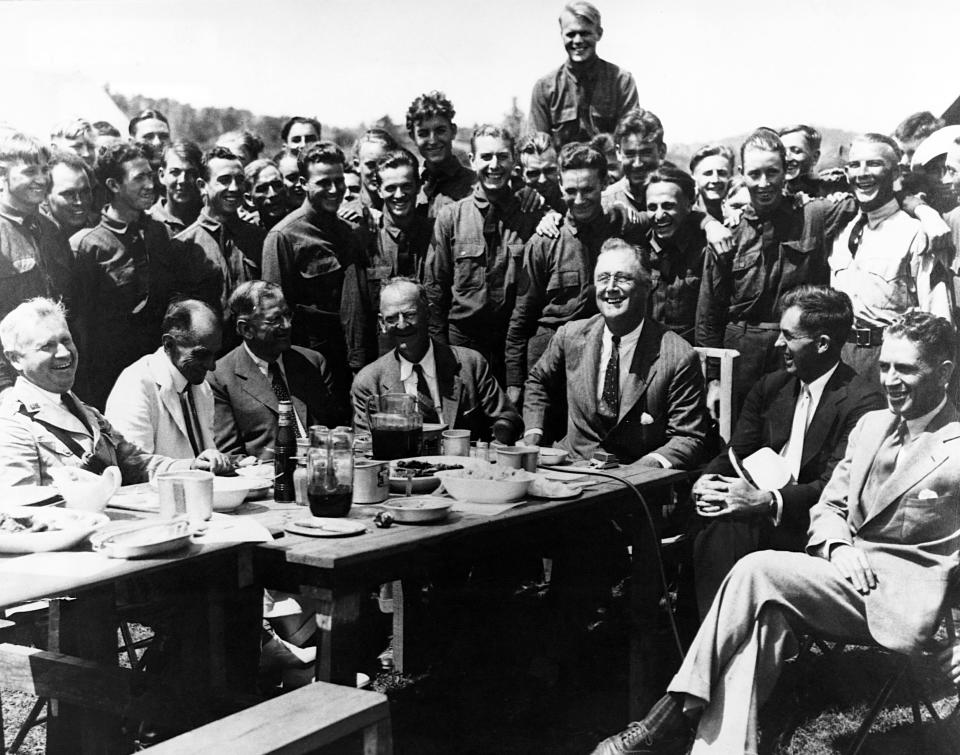 President Franklin Roosevelt visits Civilian Conservation Corps Camp #350 in Virginia's Shenandoah Valley with his aide Rexford Tugwell (far right). The CCC was an example of what the war metaphor's peacetime mobilization looked like in action. (Photo: Historical via Getty Images)
