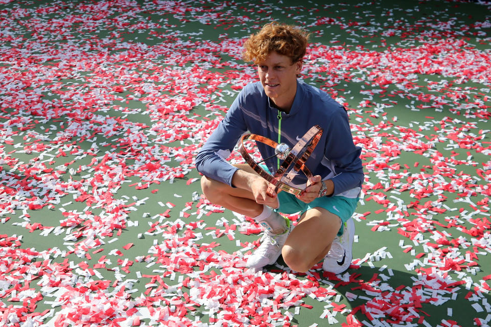 Jannik Sinner poses with the trophy.