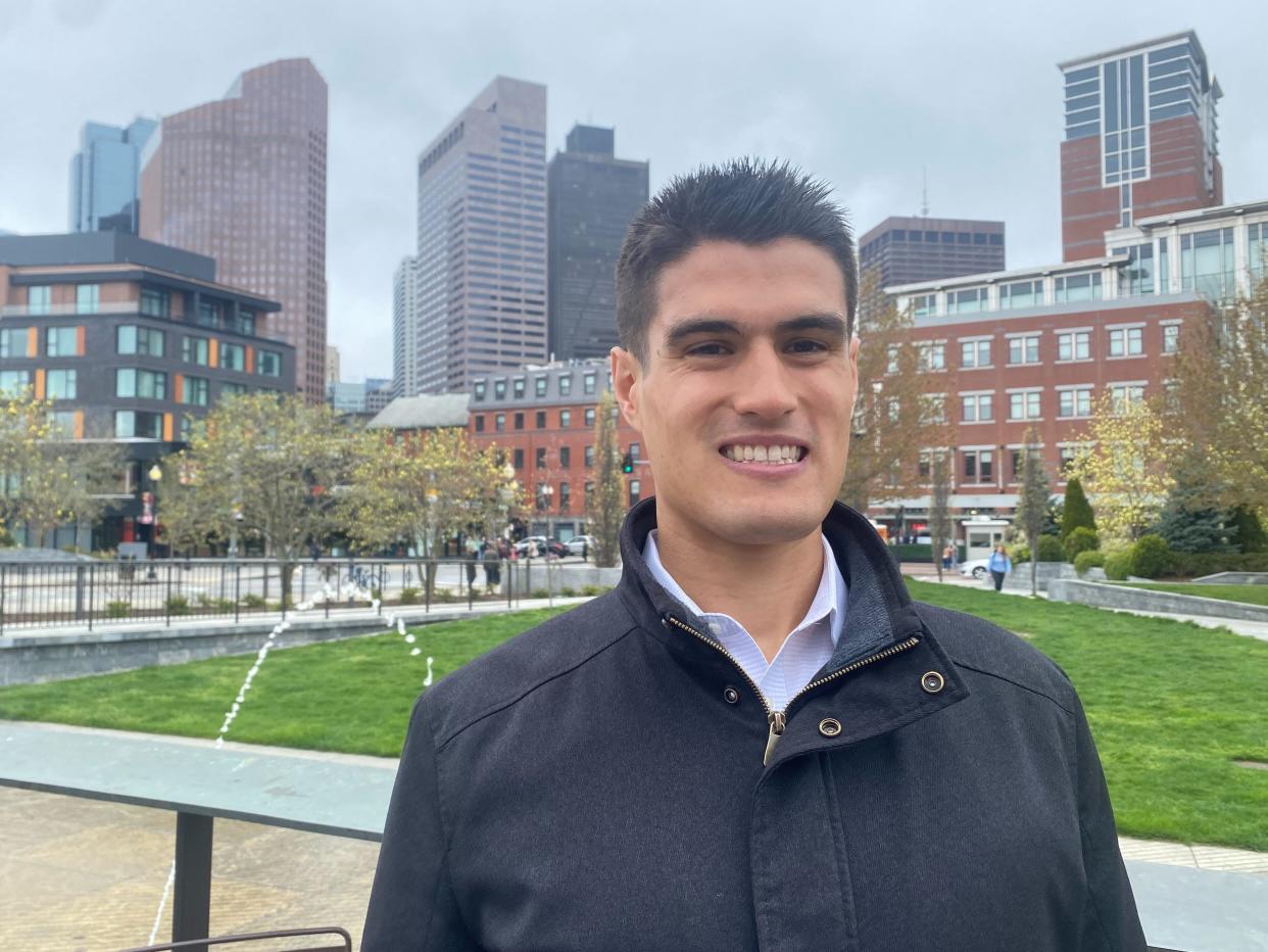 Social media influencer Davis Clarke with the Boston skyline in the background