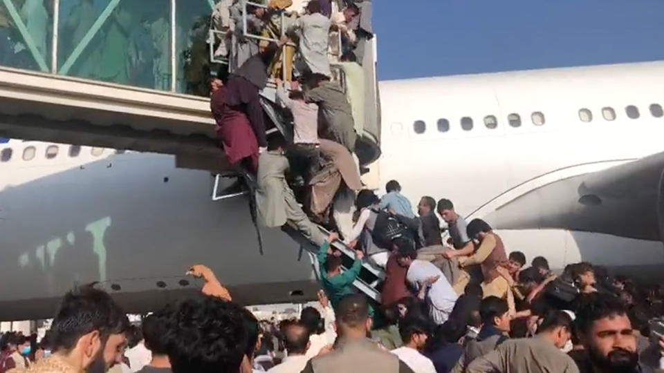 Hundreds of people tried to force their way on a plane in Kabul. Source: Twitter/@ahmermkhan