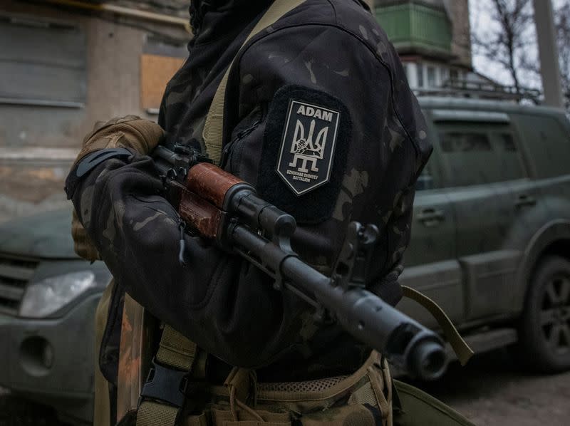 Member of pro-Ukrainian Chechen battalion holds his weapon in the town of Bakhmut