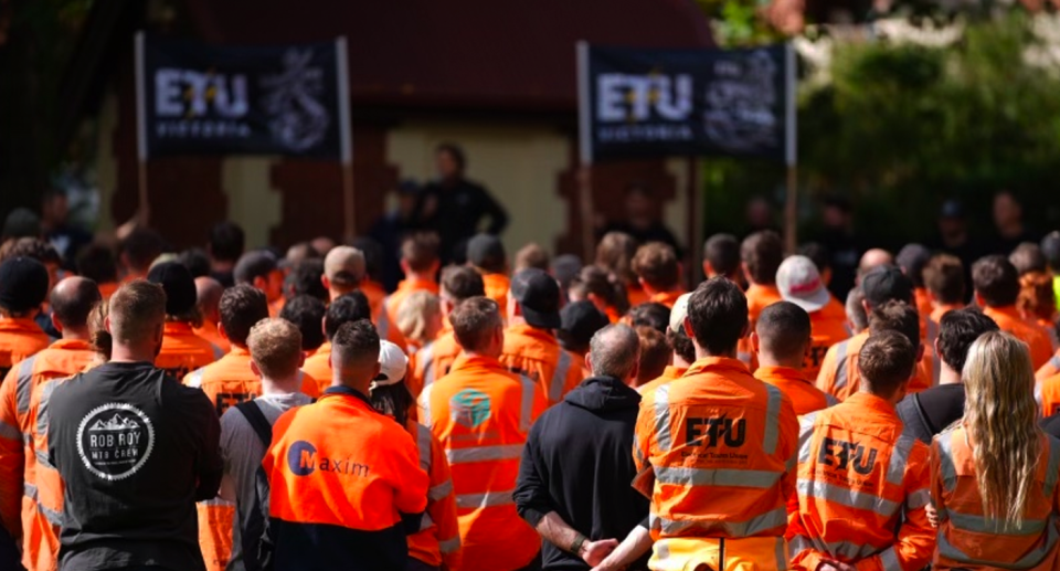 ETU members with there back to the camera at a Melbourne park.