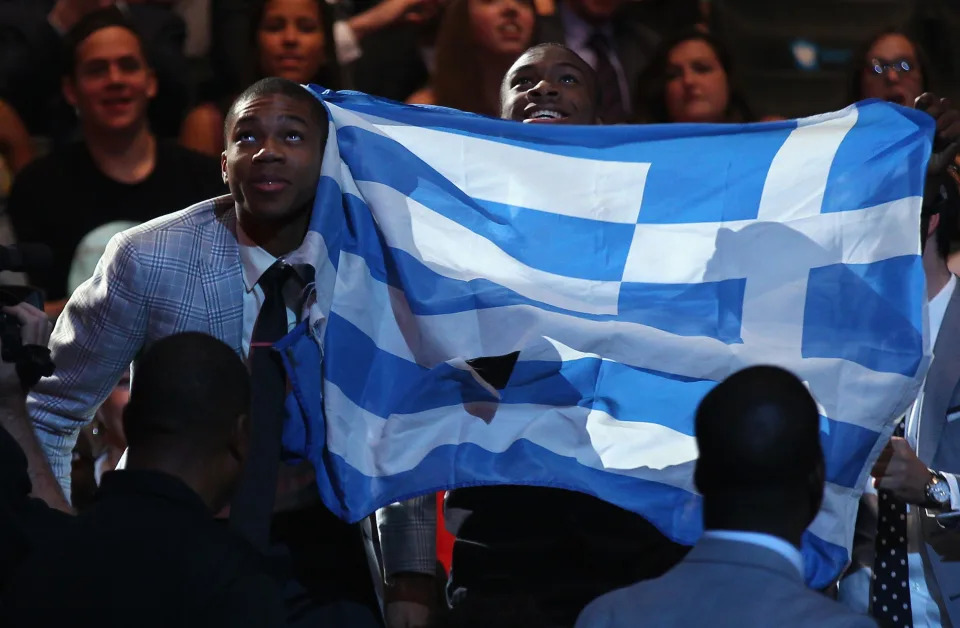 Giannis Antetokounmpo stand by the Greek flag during the 2013 NBA draft. (Mike Stobe/Getty Images)