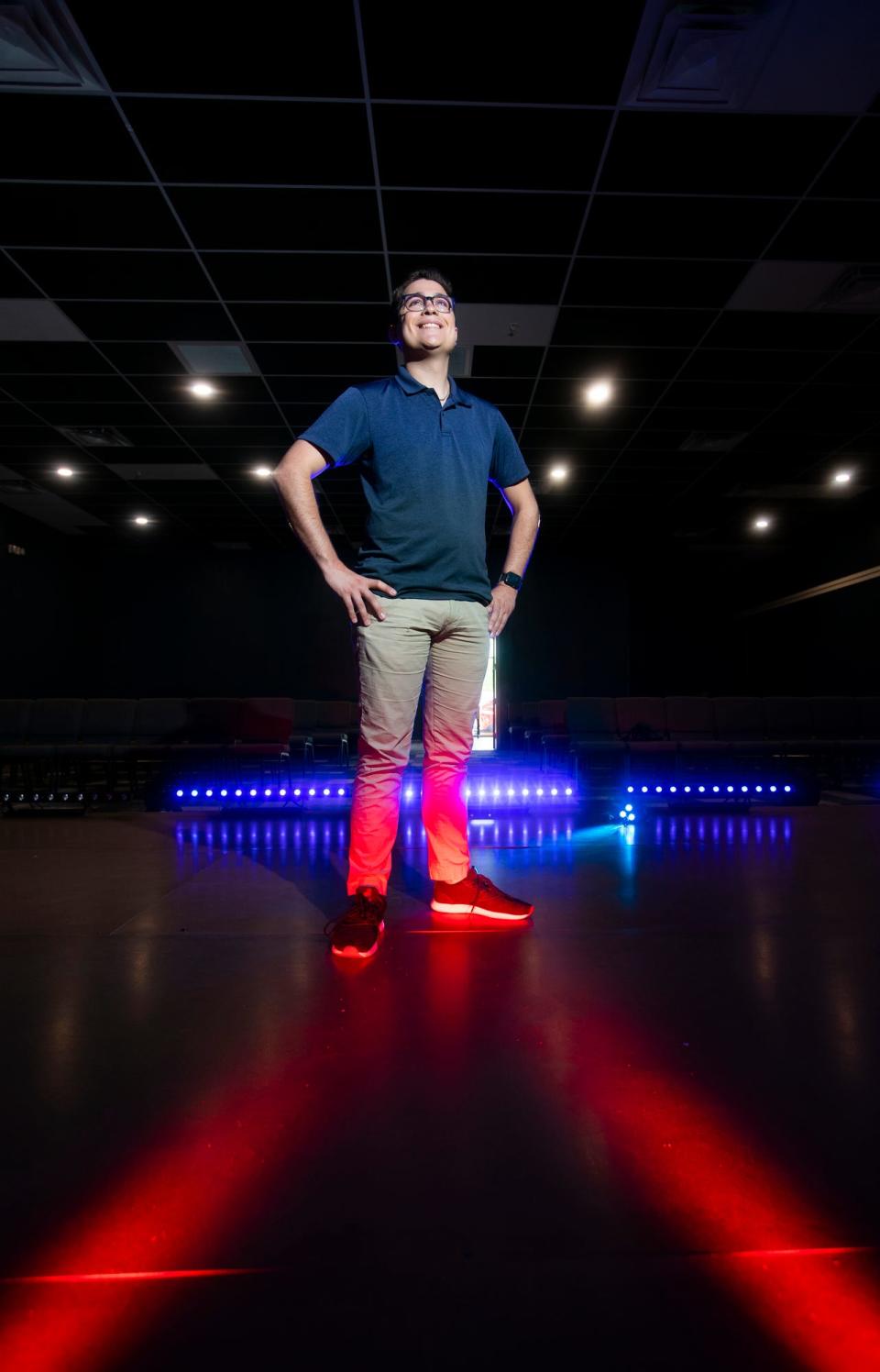 Tyler Young, founder of The Belle Theatre in Cape Coral, poses for a portrait on stage.