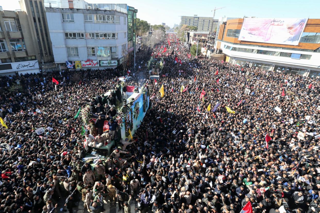 Iranian mourners gather around a vehicle carrying the coffin of slain top general Qasem Soleimani during the final stage of funeral processions, in his hometown Kerman on January 7, 2020. (Atta Kenare/AFP via Getty Images)