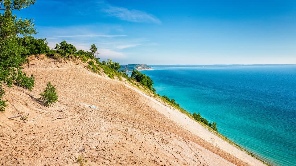 Sleeping Bear Dunes National Lakeshore boasts a number of hikes, including a strenuous one over the towering dunes that leads to Lake Michigan. - Deb Snelson/Moment RF/Getty Images