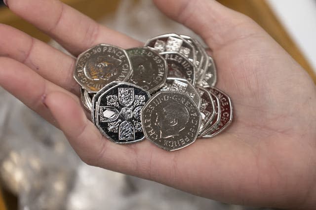 50p coins featuring the portrait of King Charles III at the Aldwych branch which is close to Clarence House, London, and is the residence of the King