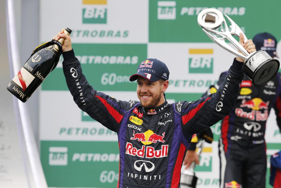 Sebastian Vettel of Germany celebrates with the trophy on the podium after the Brazilian F1 Grand Prix at the Interlagos circuit in Sao Paulo