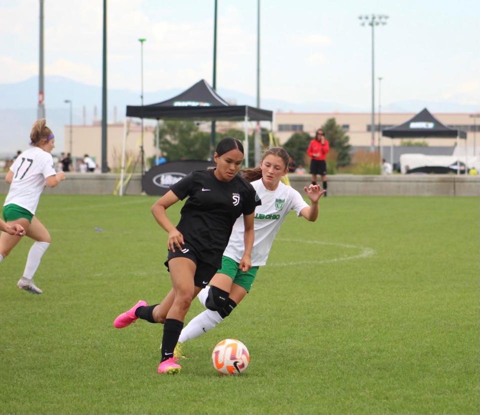 A San Juan South 14U girls soccer club member (center) dribbles the ball during one of its games in the 2023.
