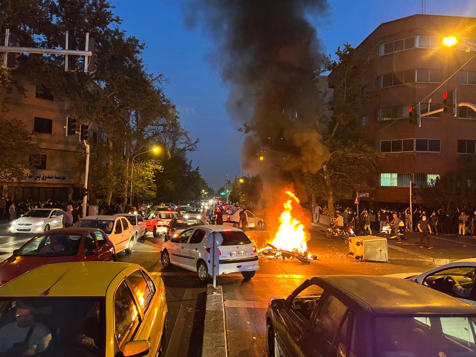 A police motorcycle burns during a protest in downtown Tehran, Iran, on Sept. 19, 2022.