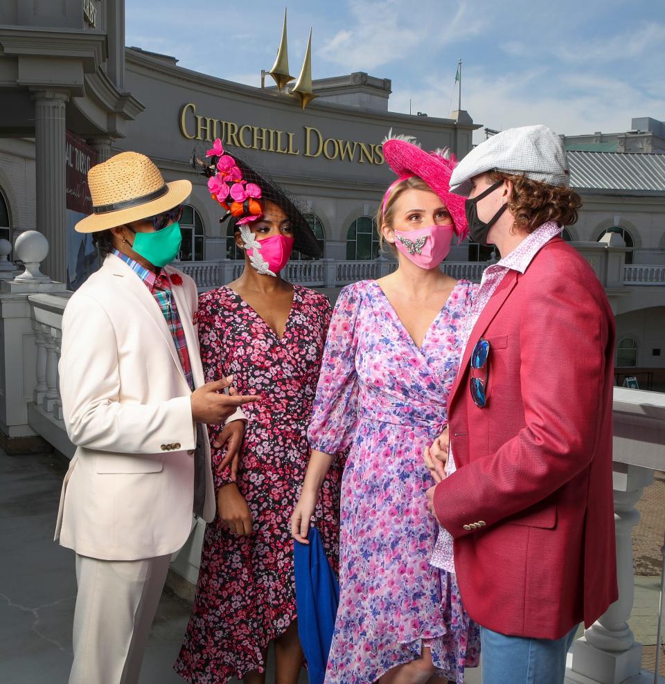 Our models are visiting the Kentucky Derby Museum. 
Description: Couple on the left, his ivory sport coat and trousers by Daniel Hecter; plaid shirt, Ralph Lauren; red boutineer, pocket square, straw fedora, navy sunglasses; all from Von Maur. Emerald green face mask by Kenzie Kapp.  Her coral/hot pink floral on black dress, by Kenzie; hot pink see-through bag, by Kurt Geiger; black sinamay platter with hot pink and orange flowers, black netting, by Giavonnio; all from Von Maur.            Pink satin face mask with pearl appliqués, by Kenzie Kapp.
Couple on the right; Her lavender/pink on white floral dress by DKNY; cobalt shrug; hot pink/gray/lavendar feathers on hot pink sinamay platter, by Frank Olive; all from Von Maur.  Butterfy broach on pink face mask, by Kenzie Kapp.
His iridescent rose/blue linen sport coat by Peter Millar; Robert Graham shirt, pink Vineyard Vines T shirt, blue chino bermuda shorts by Tommy Bahamas; blue checked newsboy cap by Stetson, all from Von Maur.