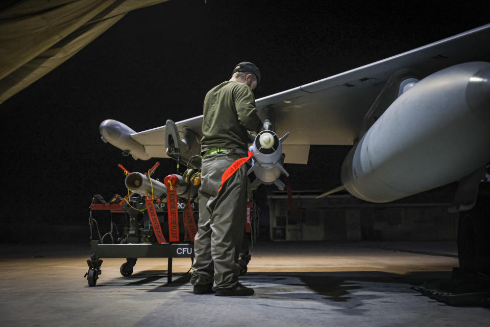 In this image provided by the UK Ministry of Defence, RAF Armourers (Weapon Technicians) prepare a Royal Air Force Typhoon FGR4 for air strikes against Houthi military targets in Yemen, in RAF Akrotiri, Sunday, Jan. 21, 2024. The U.S. and British militaries bombed eight locations used by the Iranian-backed Houthis in Yemen on Monday night, the second time the two allies have conducted coordinated retaliatory strikes on an array of the rebels' missile-launching capabilities. (AS1 Leah Jones/Ministry of Defence via AP)