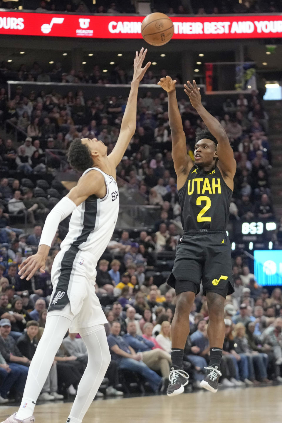 Utah Jazz guard Collin Sexton (2) shoots as San Antonio Spurs center Victor Wembanyama defends during the first half of an NBA basketball game Wednesday, March 27, 2024, in Salt Lake City. (AP Photo/Rick Bowmer)