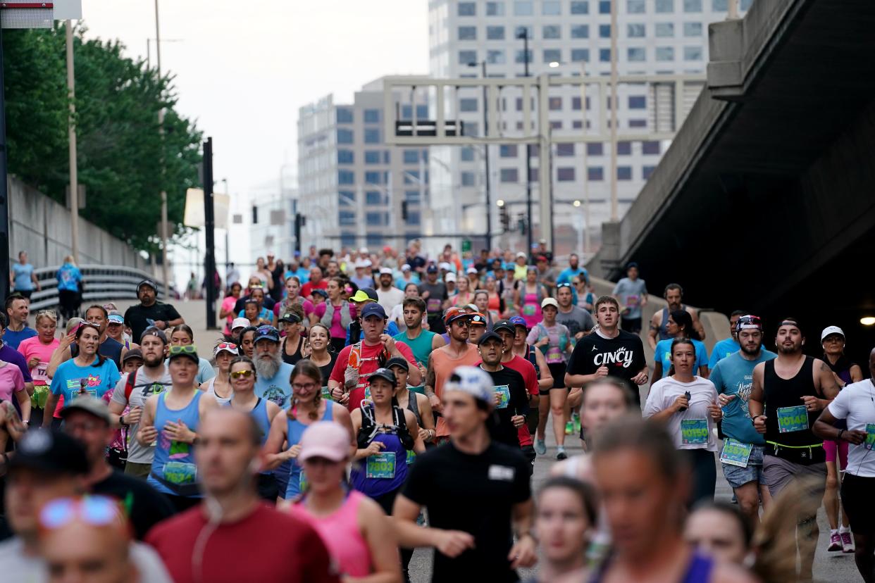 Runners make their way from Second Street down to Pete Rose Way as they approach the first mile marker during the 26th annual Flying Pig Marathon , Sunday, May 5, 2024, in Cincinnati.