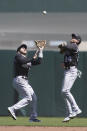 Colorado Rockies shortstop Trevor Story, left, catches a fly ball hit by San Francisco Giants' Brandon Crawford next to second baseman Ryan McMahon (24) during the second inning of a baseball game in San Francisco, Saturday, April 10, 2021. (AP Photo/Jeff Chiu)