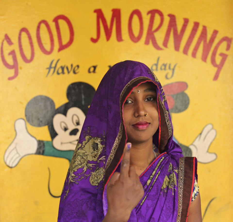 An Indian woman displays the indelible ink mark on her finger after casting her votes in Karari village, in Kausambi district of Uttar Pradesh state, India, Monday, May 6, 2019. Voting began amid scorching summer temperatures and tight security in Uttar Pradesh in northern India, where more than 25 million people are registered to cast ballots for 14 members of India's Parliament. (AP Photo/Rajesh Kumar Singh)