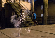 <p>A boy runs away from the firework he set off in a celebration of the Fourth of July in Chicago on Monday, July 3, 2017. Americans are celebrating their country’s birthday Tuesday with big-time fireworks, small-town parades and the quirky spectacle of competitive hot dog eating, marking a day of shared traditions in a nation that has grappled with divides this past year. (Photo: G-Jun Yam/AP) </p>