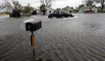 <p>A drives moves through flood waters left behind by Hurricane Harvey, Saturday, Aug. 26, 2017, in Aransas Pass, Texas. (Photo: Eric Gay/AP) </p>