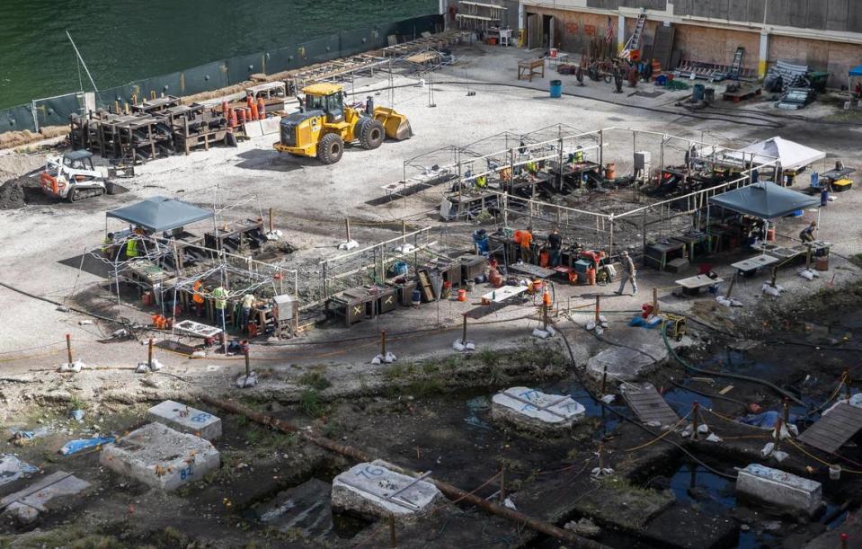 People are seen working an archaeological dig site located near Brickell on the River on Monday, Jan. 30, 2023, in Miami. Artifacts going back 7,000 years have been found at the site, along with postholes, gravesites, human remains and other evidence of substantial settlement by the Tequesta Native American tribe.