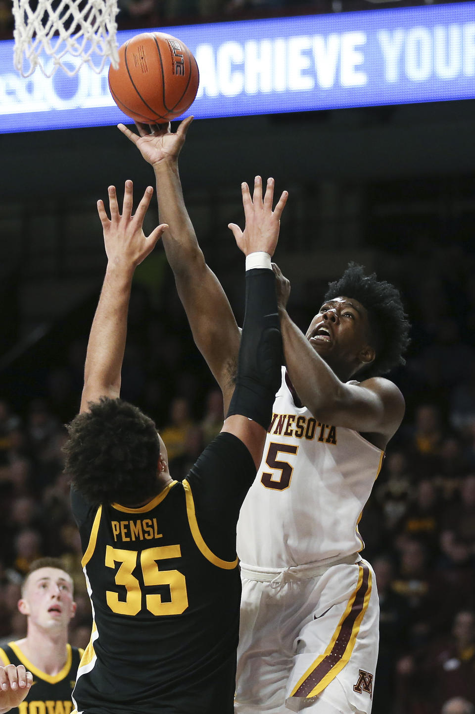 Minnesota's Marcus Carr, right, shoots against Iowa's Cordell Pemsl during an NCAA college basketball game Sunday, Feb. 16, 2020, in Minneapolis. (AP Photo/Stacy Bengs)