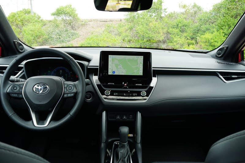 A red 2023 Toyota Corolla Cross Hybrid.