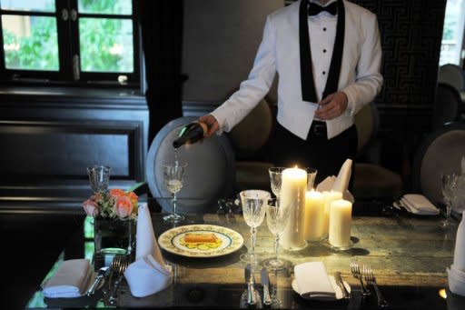 A waiter pours white wine into a glass to demonstrate the Hullett House hotel's recreation of the Titanic's last meal to mark the disaster's 100th anniversary in Hong Kong. The diners will be served by waiters dressed in uniforms like those on the Titanic and eat off fine bone china plates as used on board