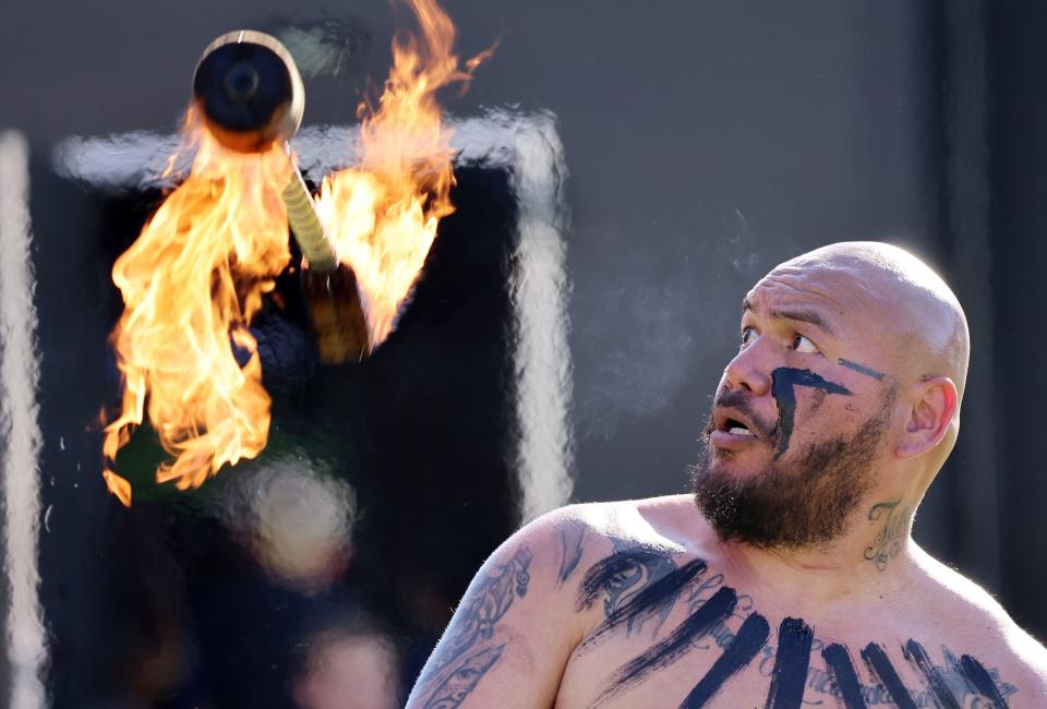 Fire Knife Dancer Martin Tevaga spins and catches his torch as his group performs as BYU holds a party to celebrate their move into the Big 12 Conference with music, games and sports exhibits in Provo on Saturday, July 1, 2023. | Scott G Winterton, Deseret News