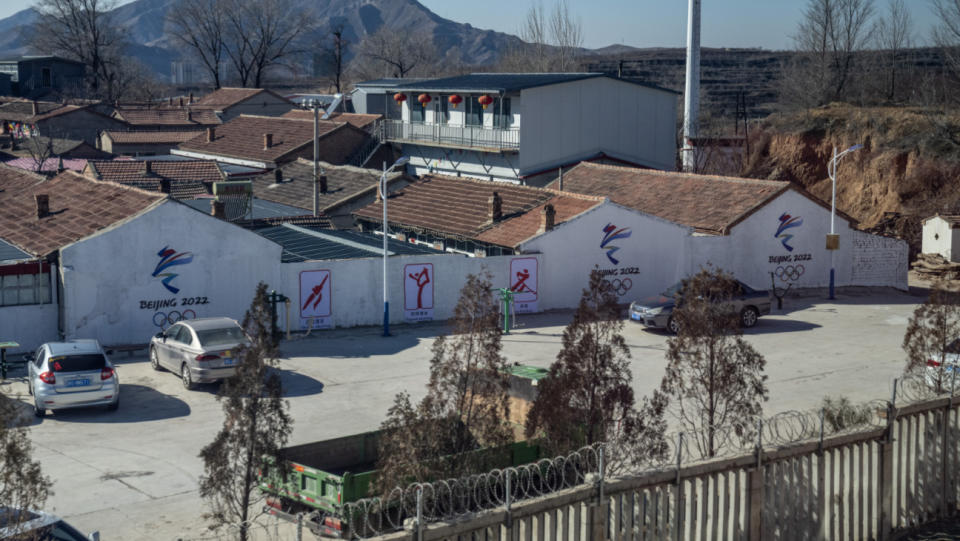 Beijing 2022 Winter Olympic branding is displayed on the side of a brick building along the high-speed rail line from Beijing to Zhangjiakou Olympic zone, on February 1, 2022 in Zhangjiakou, China.