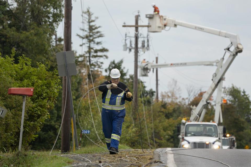 Nova Scotia Power crews work to fix power lines near Lower Barneys River in Pictou County, N.S., on Sept. 28 following significant damage brought by Fiona. THE CANADIAN PRESS/Darren Calabrese