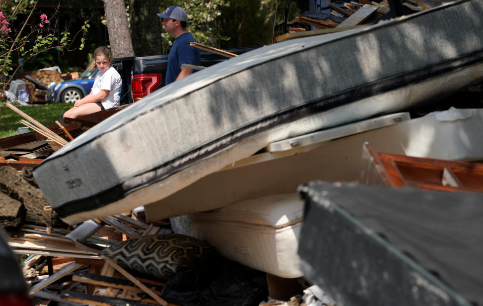 A girl sits amid giant piles of trash on&nbsp;Sept. 2.