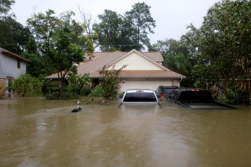 Houses and cars are seen partially submerged by flood waters in east Houston on Monday.&nbsp; (Photo: Jonathan Bachman / Reuters)