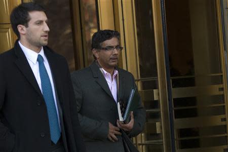 Conservative commentator and best-selling author, Dinesh D'Souza (R) exits the Manhattan Federal Courthouse in New York, January 24, 2014. REUTERS/Brendan McDermid