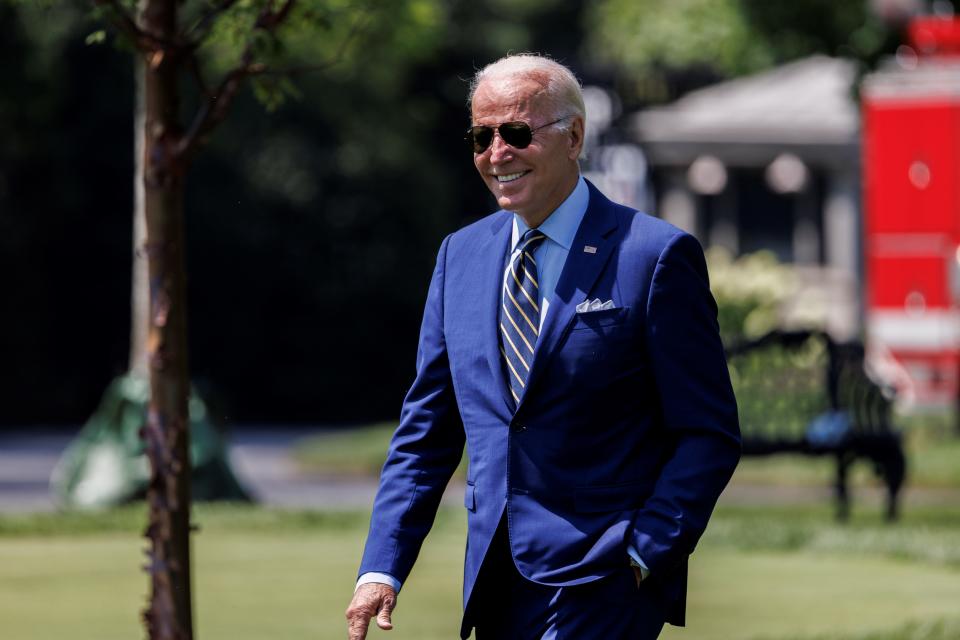 President Biden walks on the South Lawn of the White House.