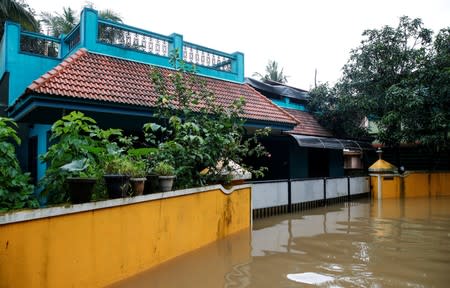 A view shows exteriors of a partially submerged residential house on the outskirts of Kochi