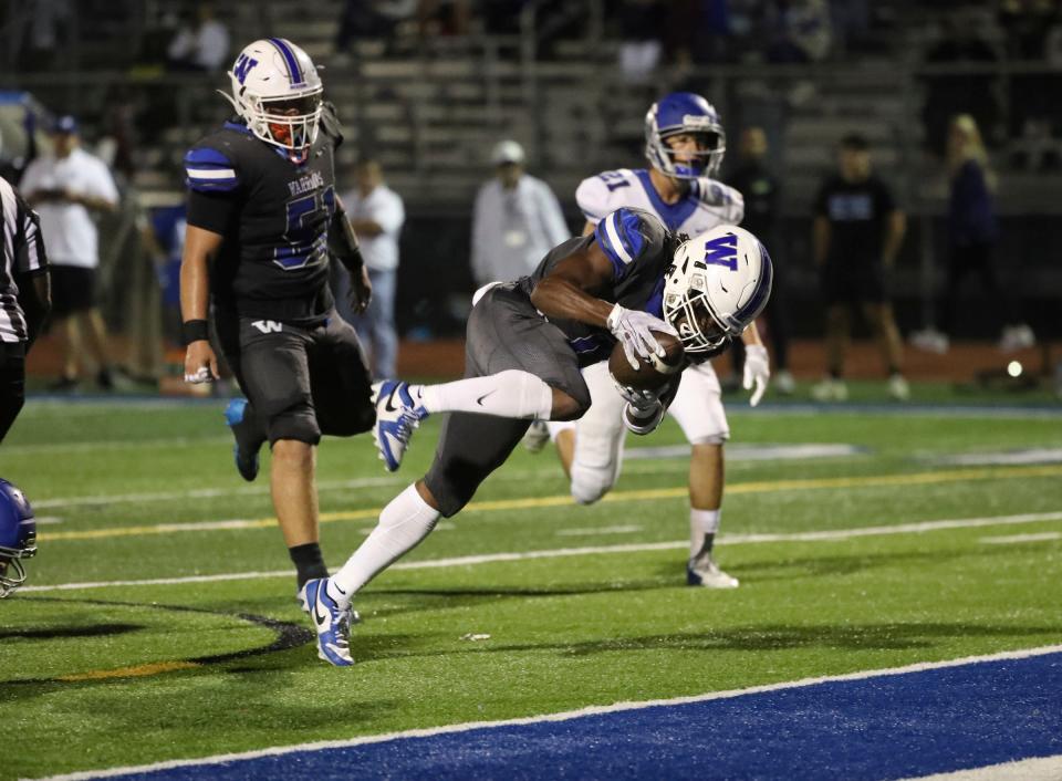 Walled Lake Western running back Nick Thompson scores against White Lake Lakeland during second-half action at Walled Lake Western High School on Friday, Sept. 22, 2023.