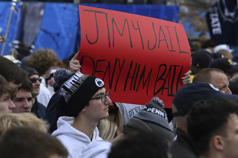 Fans display a sign about Michigan head coach Jim Harbaugh outside of Beaver Stadium before an NCAA college football game against Penn State, Saturday, Nov. 11, 2023, in State College, Pa. (AP Photo/Barry Reeger)