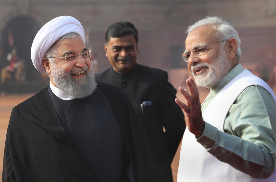 FILE - In this Feb. 17, 2018 file photo, Indian Prime Minister Narendra Modi, right, talks to Iranian President Hassan Rouhani, left, during a ceremonial reception for Rouhani at the Indian presidential palace in New Delhi, India. Modi won a second term in office in May, 2019, by presenting a muscular image to voters by ordering an air strike inside Pakistan in response to a suicide attack on Indian paramilitary forces in troubled Kashmir ahead of national elections. But he will now be required to navigate deftly in a climate of deteriorating trade relations between the United States and China and its fallout on India and rising tensions between the United States and Iran. (AP Photo/Manish Swarup, File)
