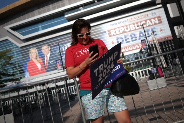 A supporter of Republican presidential candidate Donald Trump waits for the start of the GOP primary debate Wednesday in Milwaukee, Wisconsin.
