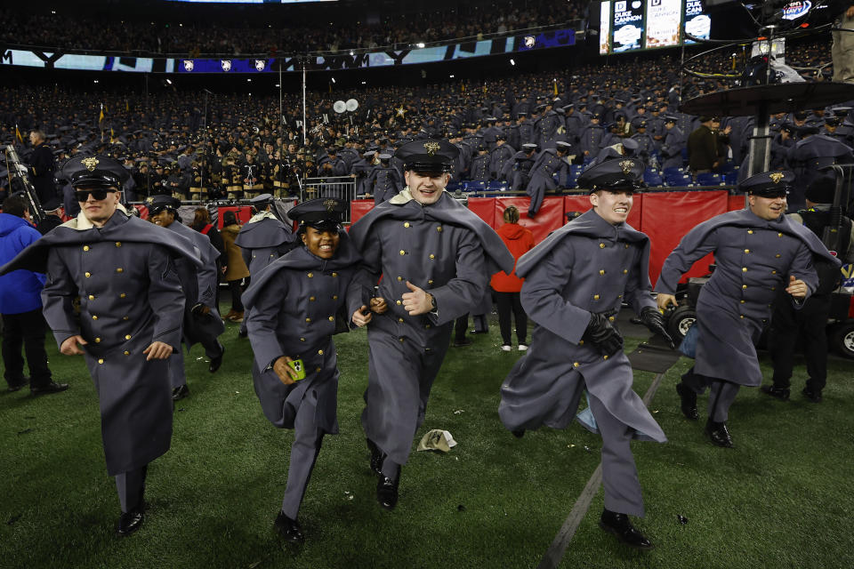 Army Cadets storm the field after defeating Navy 17-11 in an NCAA college football game at Gillette Stadium Saturday, Dec. 9, 2023, in Foxborough, Mass. (AP Photo/Winslow Townson)