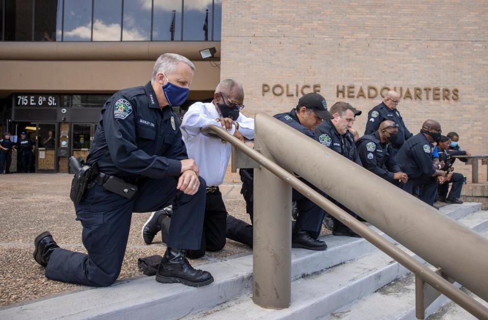 Then-Police Chief Brian Manley kneels for 8 minutes, 46 seconds in memory of George Floyd at the police headquarters on June 6, 2020. Several Austin police officers and protesters kneeled while other protesters called the event a hollow gesture and a photo op.